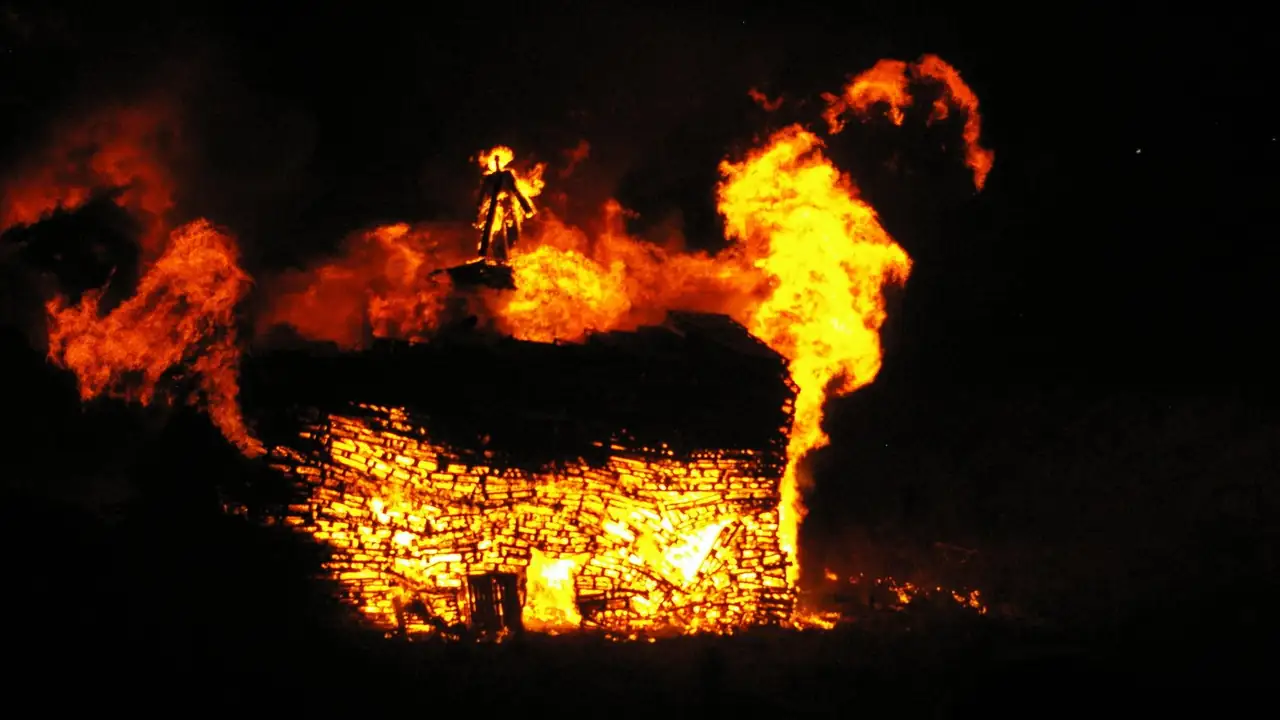 A Guy Fawkes bonfire burning at night